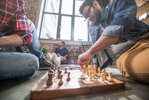 Employees playing chess in an office environment