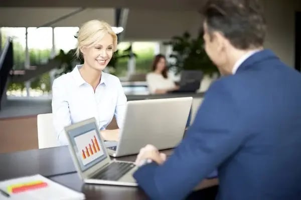 depositphotos_132812318-stock-photo-happy-colleagues-using-a-laptops