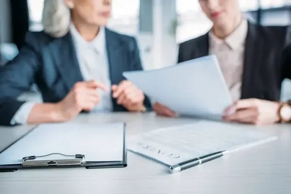 depositphotos_153606394-stock-photo-clipboard-and-contract-on-table