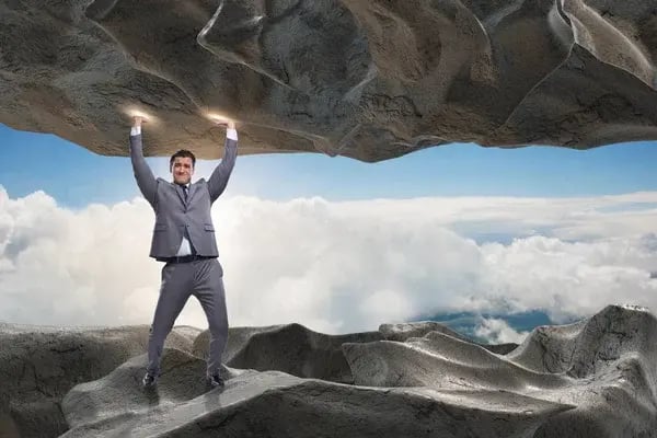 depositphotos_168508818-stock-photo-businessman-supporting-stone-under-pressure