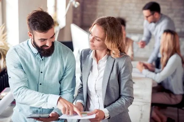 depositphotos_177139316-stock-photo-two-colleagues-discussing-about-the