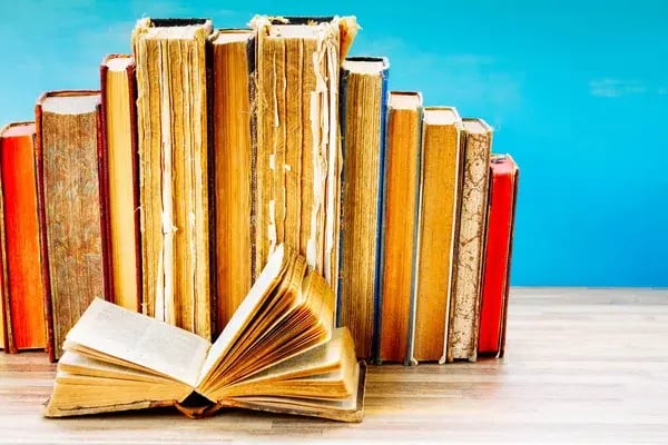 depositphotos_201541410-stock-photo-pile-of-old-books