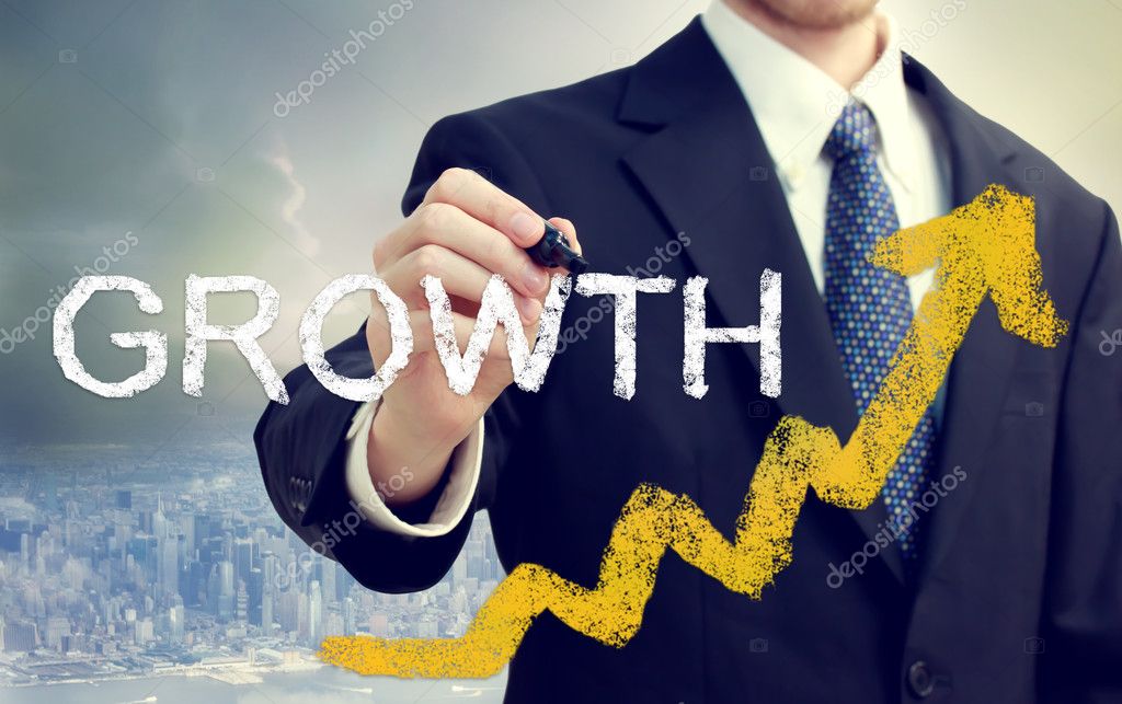 Businessman writing Growth