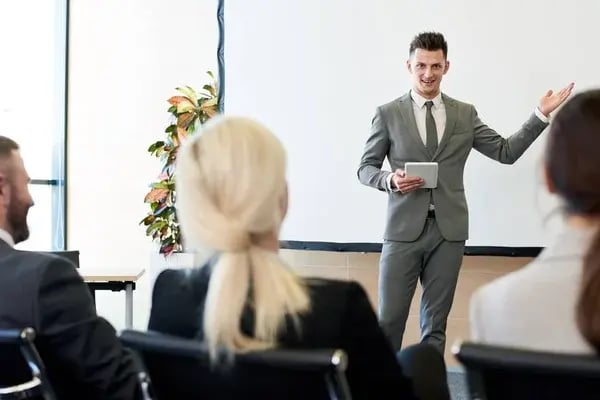 depositphotos_209974814-stock-photo-portrait-successful-young-businessman-giving
