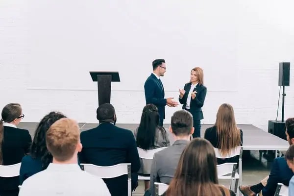 depositphotos_219685006-stock-photo-colleagues-talking-front-multicultural-audience