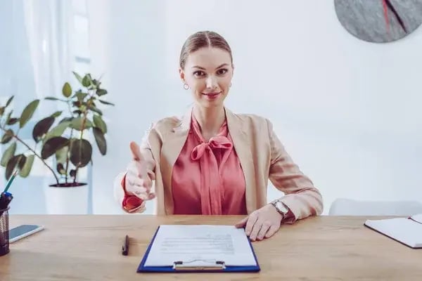 depositphotos_254319676-stock-photo-cheerful-attractive-recruiter-gesturing-clipboard