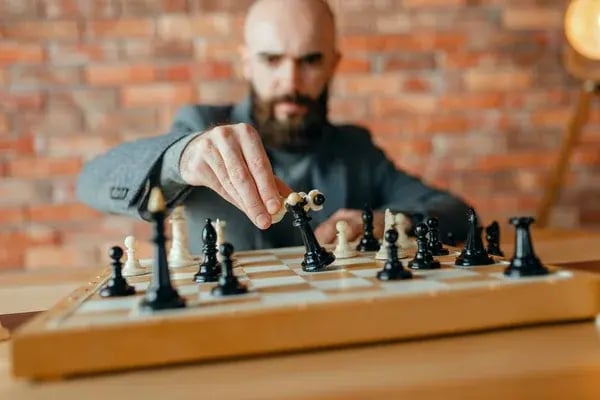 depositphotos_273458590-stock-photo-male-chess-player-playing-white