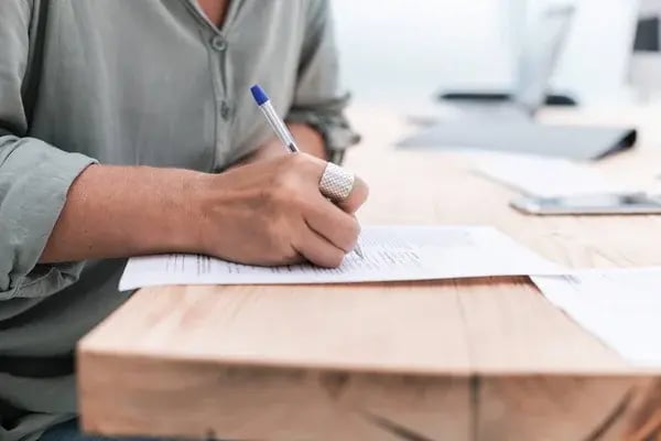 depositphotos_301956200-stock-photo-close-up-business-woman-writing