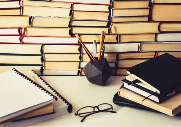 depositphotos_322719802-stock-photo-stack-of-books-notebook-laptop