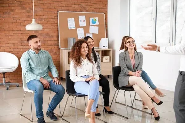 depositphotos_326224218-stock-photo-colleagues-listening-to-speaker-at