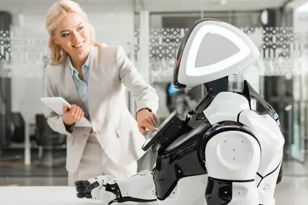depositphotos_344437966-stock-photo-smiling-businesswoman-operating-robot-while