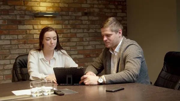 depositphotos_358064828-stock-photo-colleagues-looking-at-tablet-together
