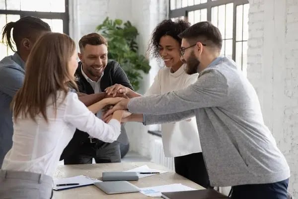 depositphotos_378494426-stock-photo-successful-diverse-employees-stacking-hands