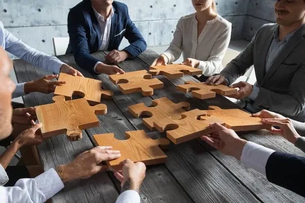depositphotos_393212578-stock-photo-business-people-team-sitting-meeting