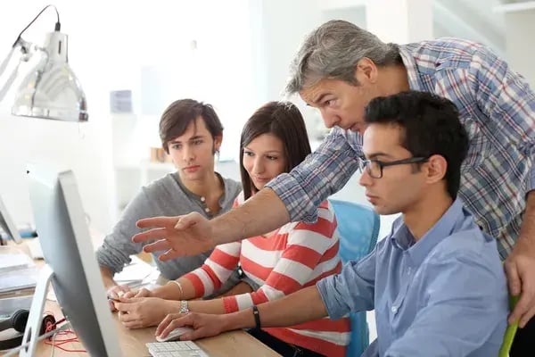 depositphotos_41328285-stock-photo-teacher-with-students