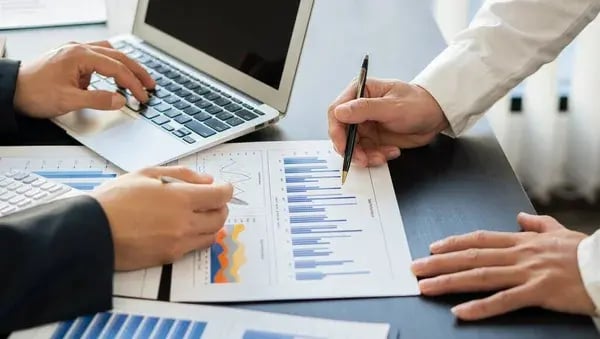 depositphotos_472772400-stock-photo-business-analysts-create-graphs-investment