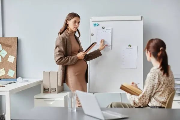 depositphotos_544635360-stock-photo-pregnant-businesswoman-presenting-her-report