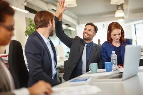 depositphotos_620727416-stock-photo-winners-win-teamwork-colleagues-giving