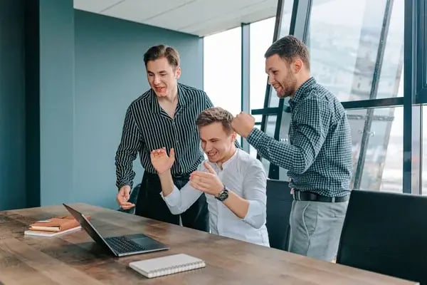 depositphotos_647047312-stock-photo-satisfied-young-businessmen-using-laptops