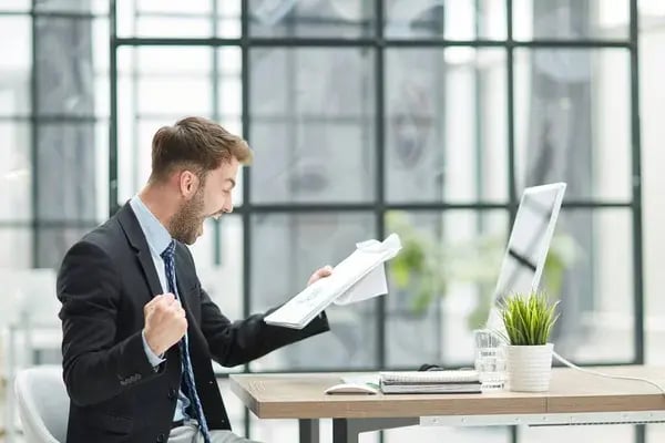 depositphotos_648889708-stock-photo-energetic-businessman-celebrating-in-the-office