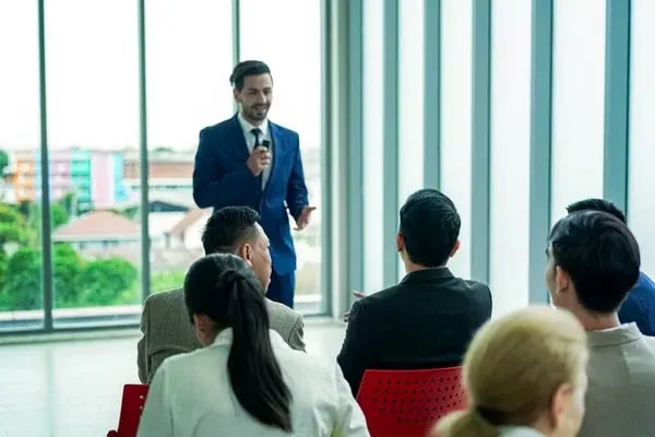 depositphotos_667515944-stock-photo-conference-meeting-business-people-sitting (1)