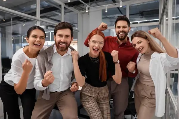 depositphotos_688335698-stock-photo-team-employees-celebrating-success-office