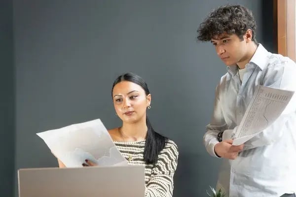depositphotos_883782608-stock-photo-young-professionals-discussing-financial-reports
